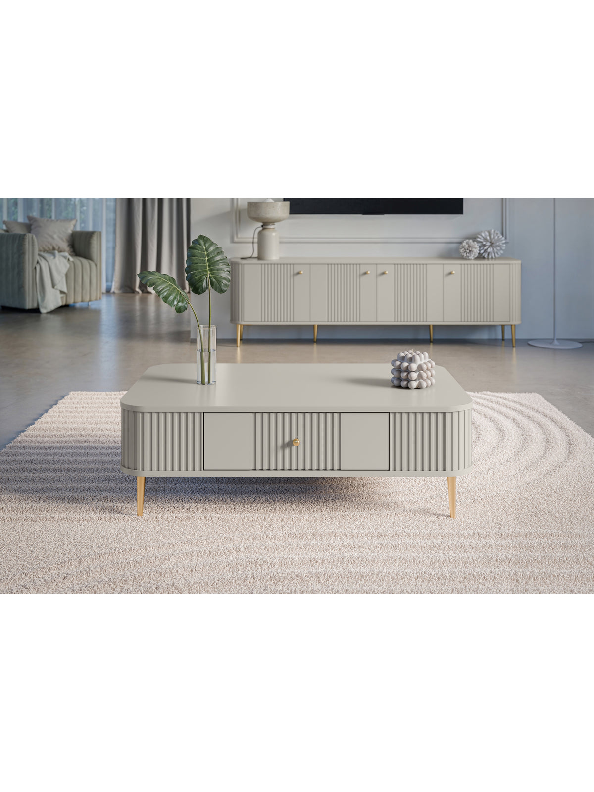 Stolik kawowy Vesper 103x60 cm kaszmir z ryflowanym frontem i złotymi nogami